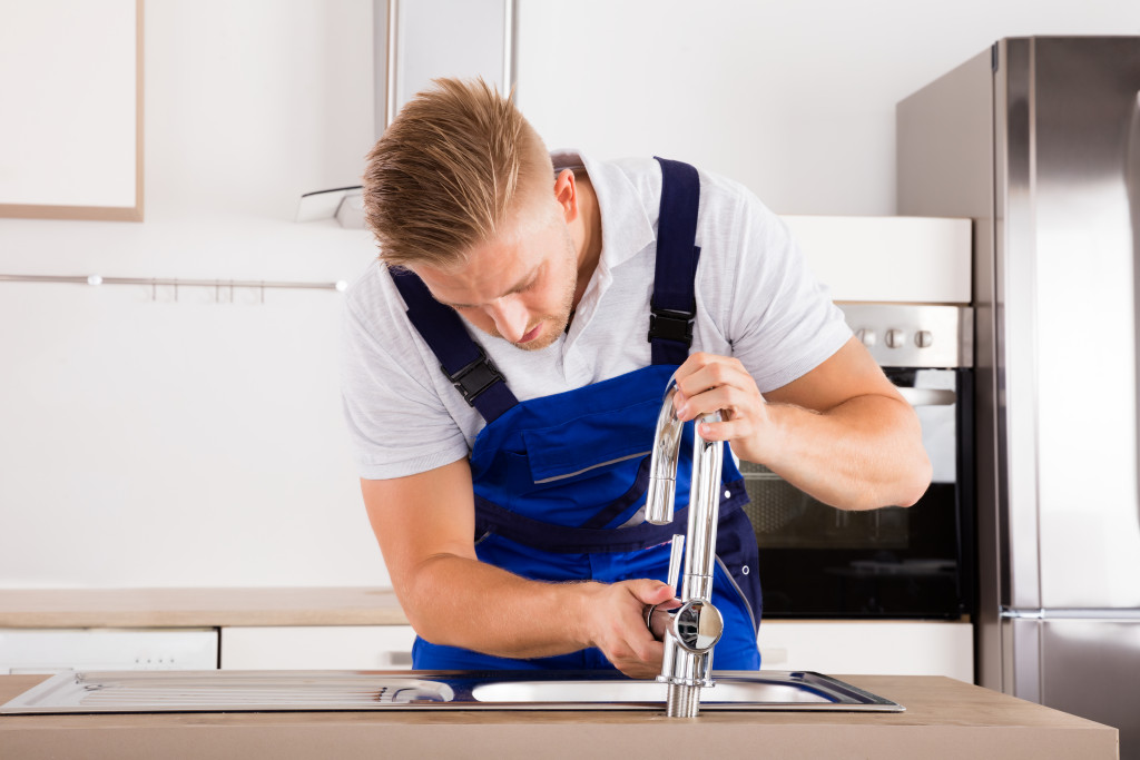 a plumber fixing the sink