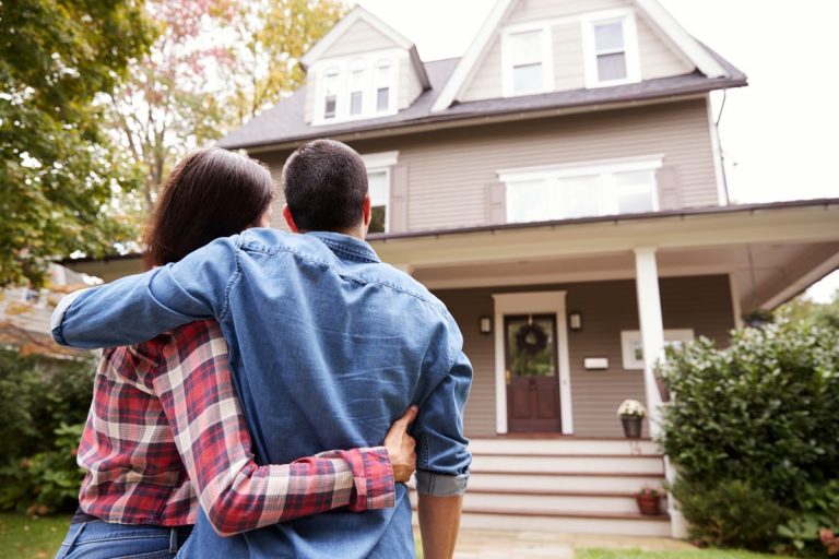 couple walking towards house