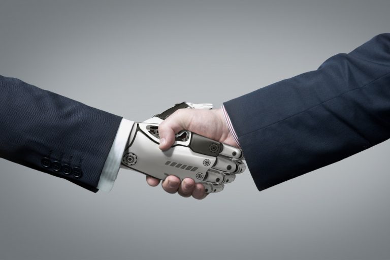 business hand shaking hand of robot hand showing AI concept