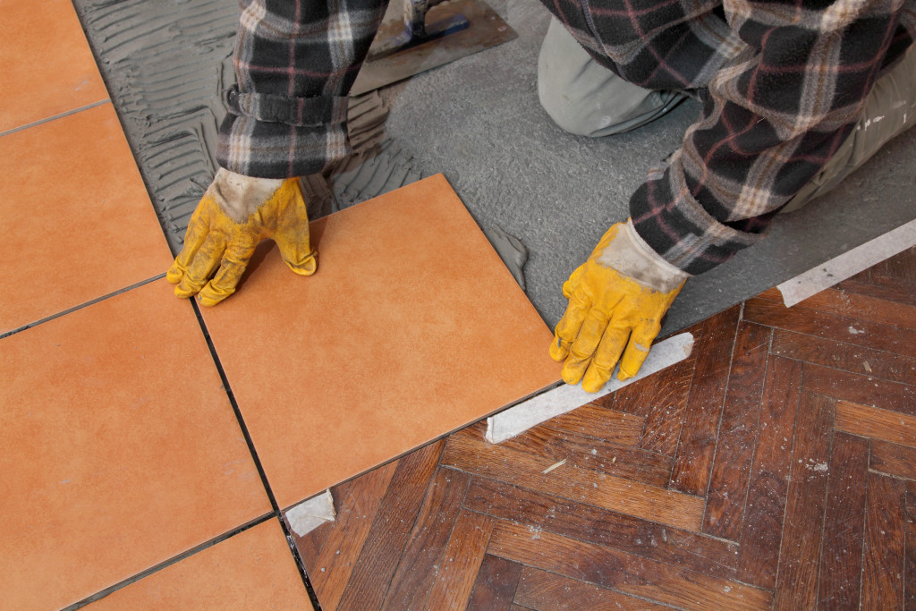 Worker installing new tiles in a home.