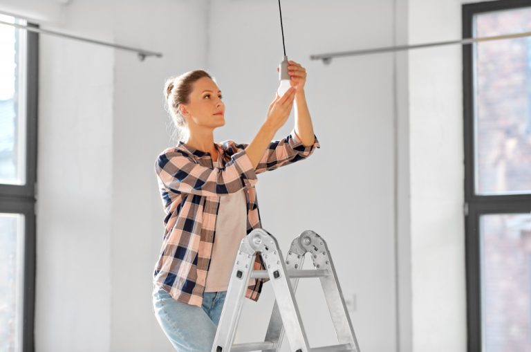 woman on a ladder changing led lights